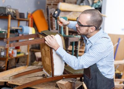 Expert repairing a wooden chair